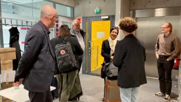 A group of people in the lobby.