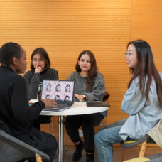 Students of the Masgter's Degree Programme sitting at the lobby.