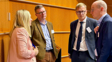 Four people discussing.