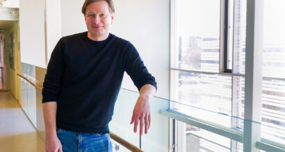 Picture of Laaninen smiling moderately in a corridor at the University