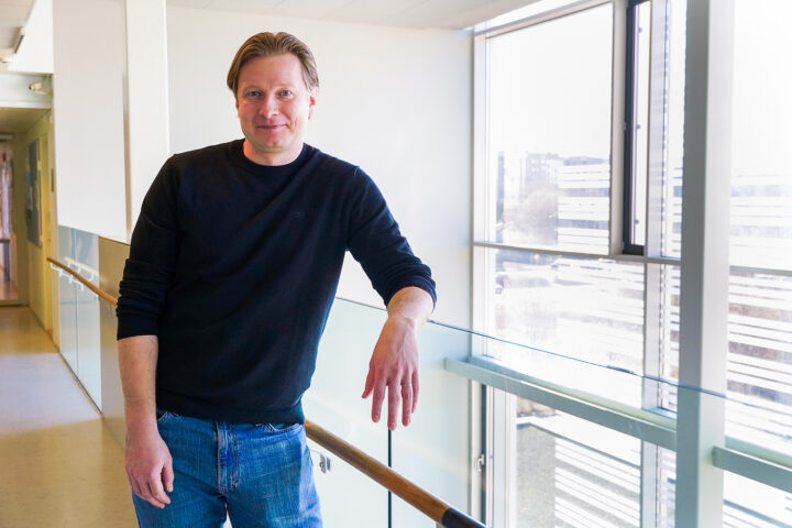Picture of Laaninen smiling moderately in a corridor at the University