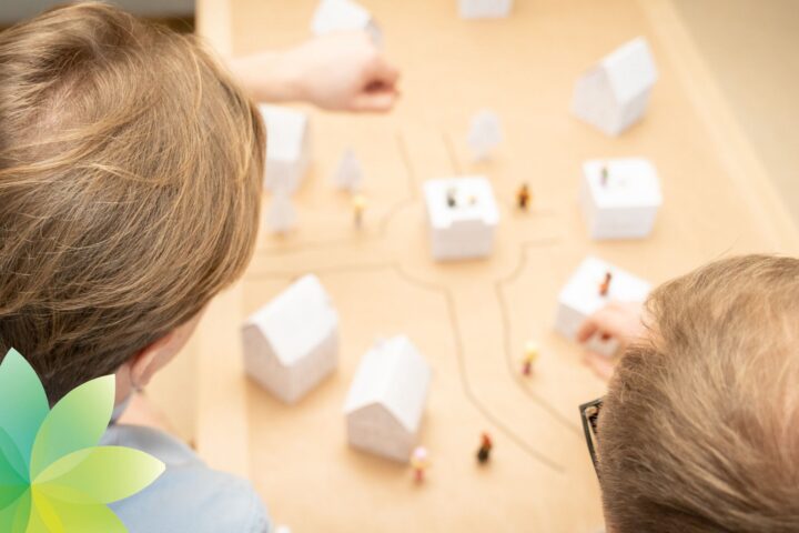 Tunnistamattomat tutkijat tutkivat kaupungin pienoismallia.