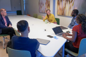 Group of people by the table.
